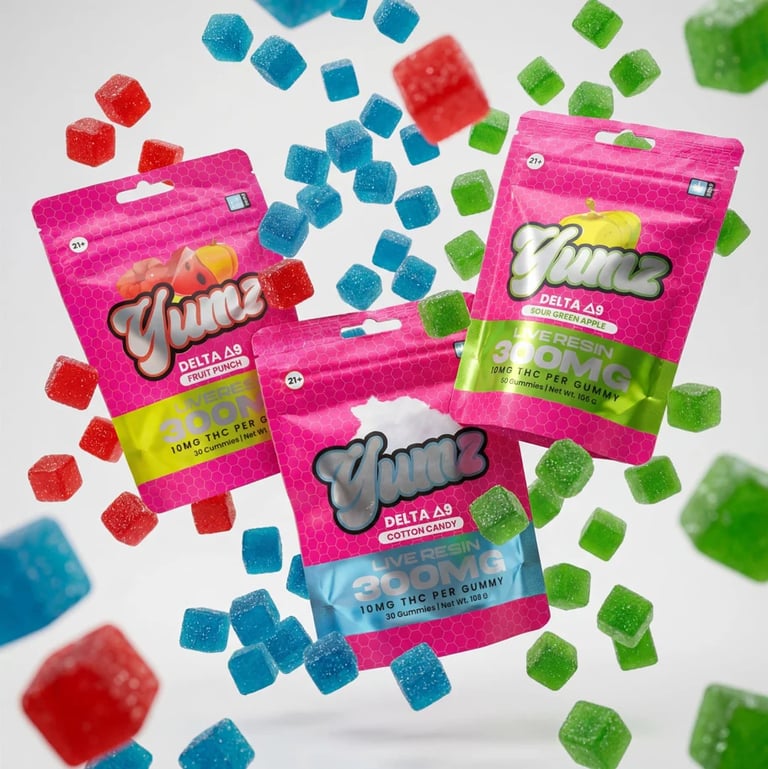 Three Vimm brand Delta-8 gummy packages in pink with colorful gummy candies scattered around them on a white background